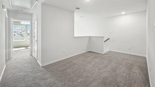 an empty room with a empty space and windows