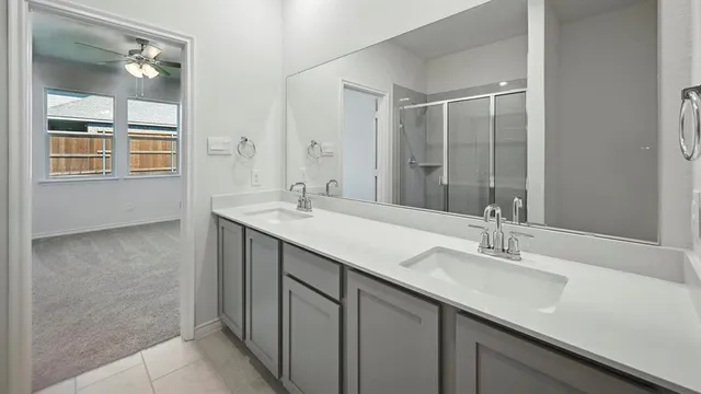 a bathroom with a double vanity sink a and mirror