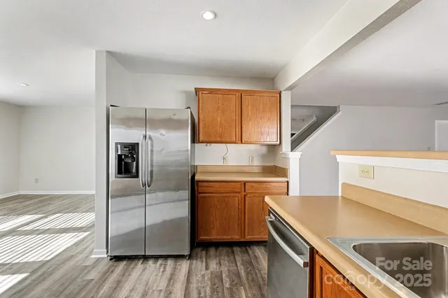 a kitchen with granite countertop wooden floors and stainless steel appliances