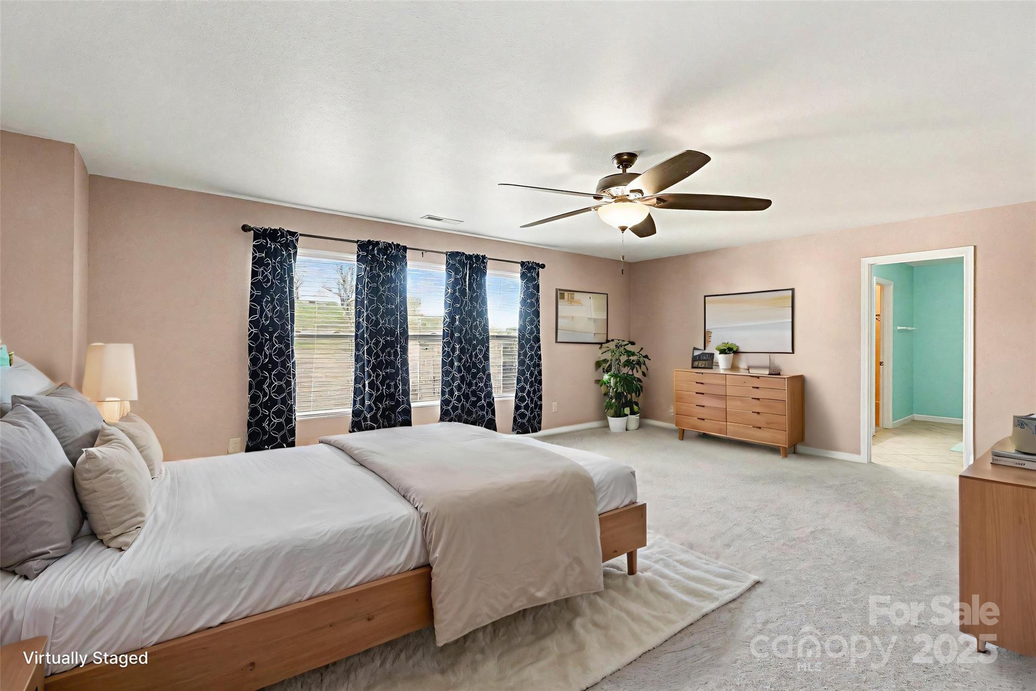 3901 Shasta Circle Clover, SC 29710 - Photo 20 of 36 a spacious bedroom with a bed and a chandelier