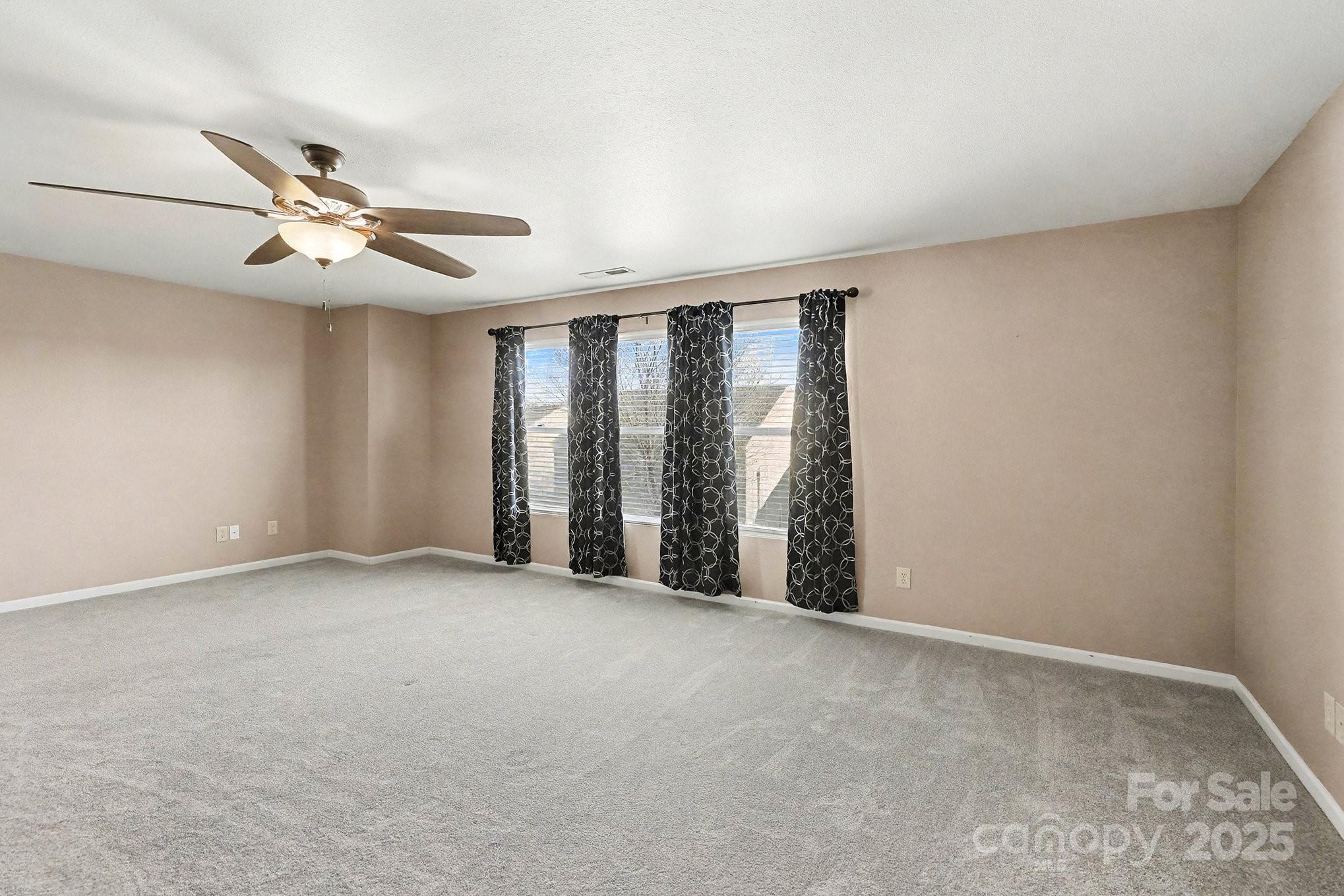 3901 Shasta Circle Clover, SC 29710 - Photo 21 of 36 an empty room with chandelier fan and windows