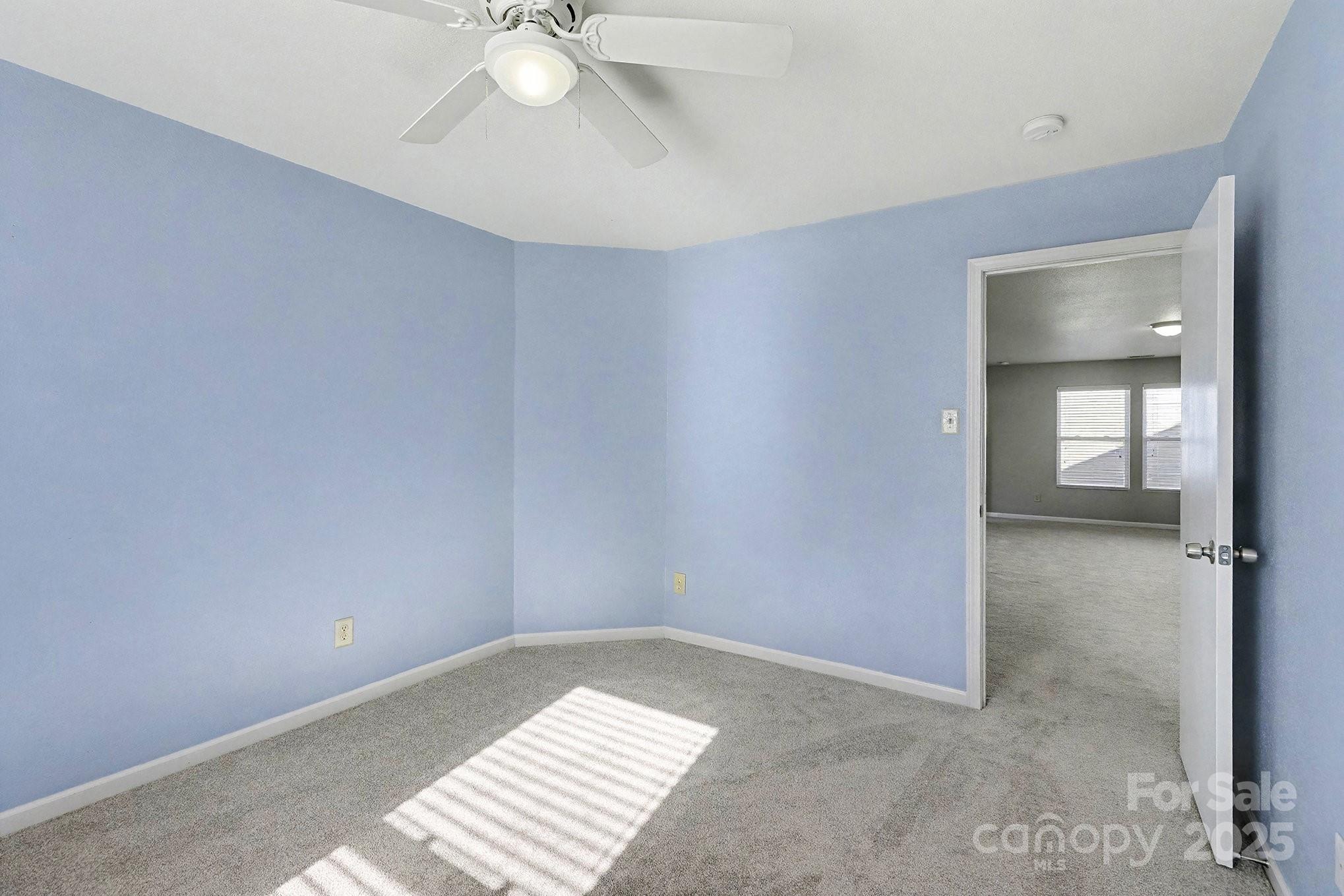 3901 Shasta Circle Clover, SC 29710 - Photo 30 of 36 an empty room with a chandelier fan and windows