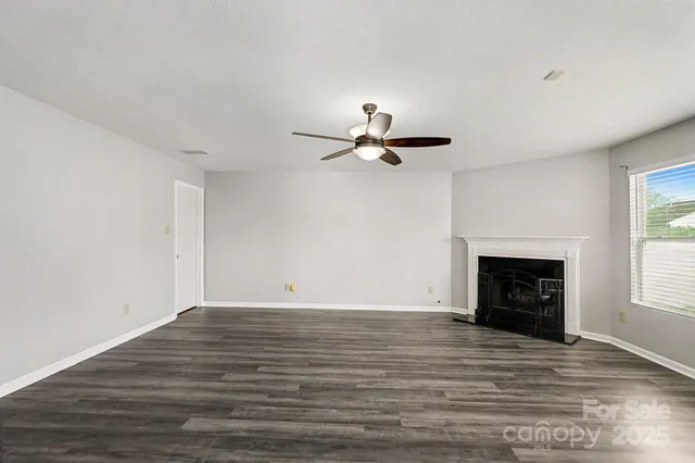 a view of a livingroom with a fireplace and window