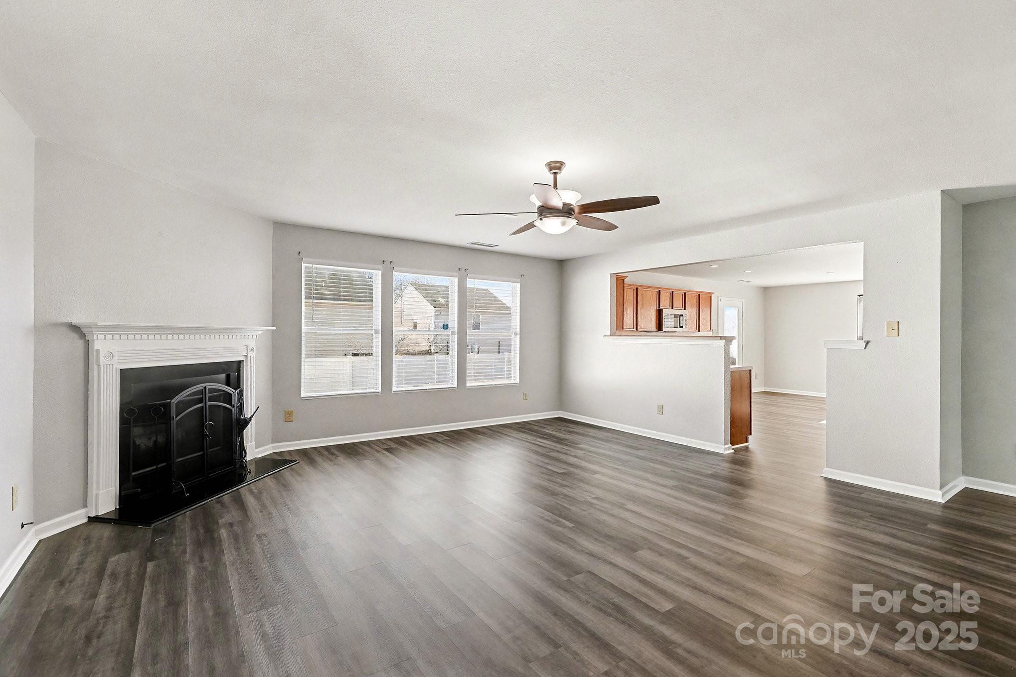 3901 Shasta Circle Clover, SC 29710 - Photo 6 of 36 a view of an empty room with wooden floor fireplace and a window