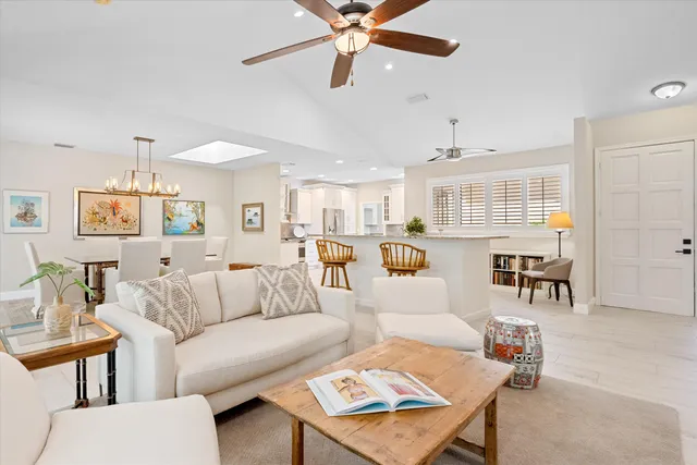 a living room with furniture and kitchen view