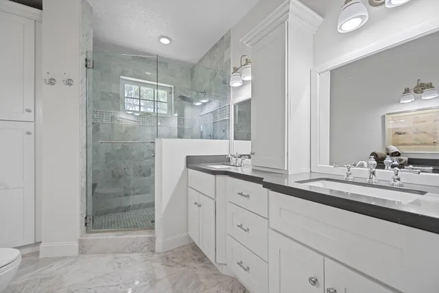 a bathroom with double sink and a mirror