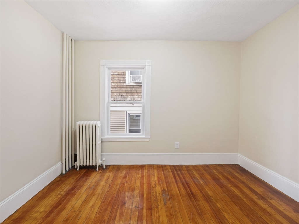 75 Bellingham Street Chelsea, MA 02150 - Photo 11 of 42 an empty room with wooden floor and windows