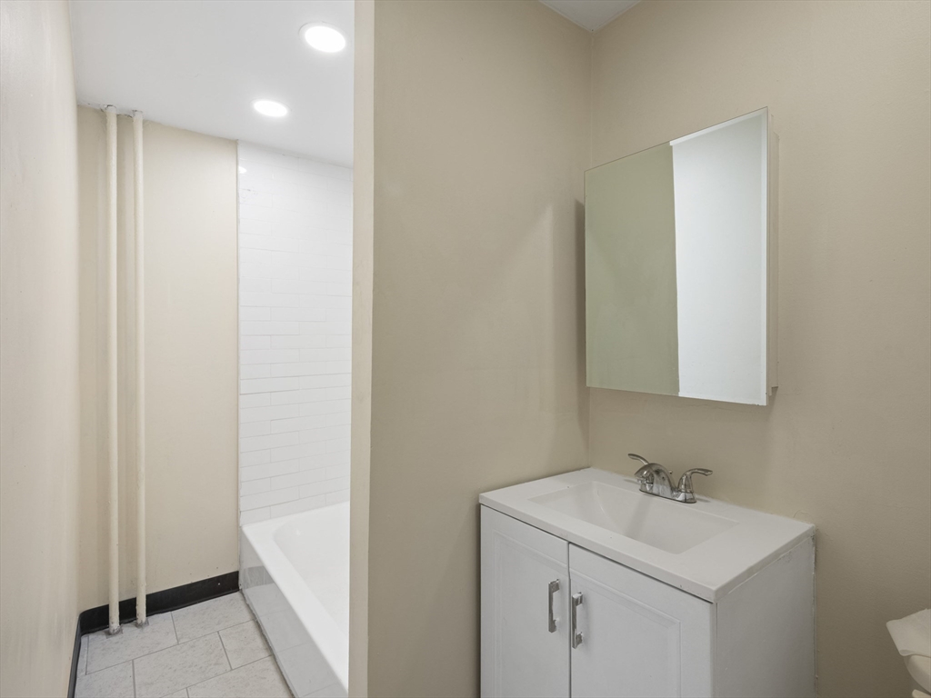 75 Bellingham Street Chelsea, MA 02150 - Photo 24 of 42 a bathroom with a sink a toilet and a mirror