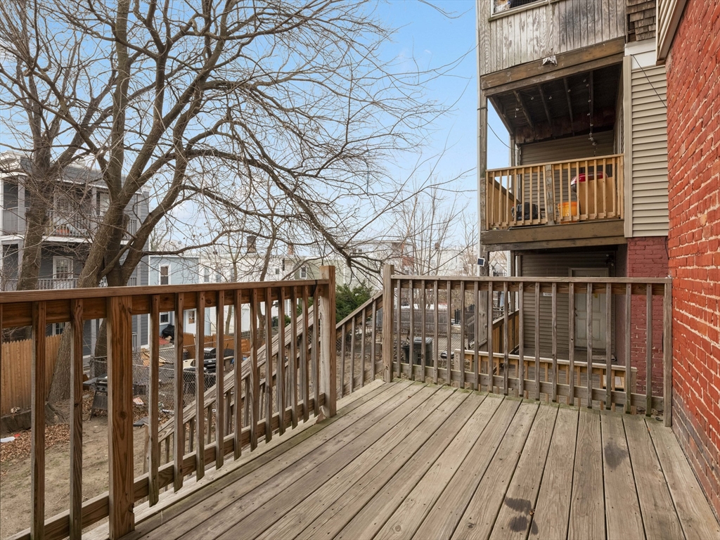 75 Bellingham Street Chelsea, MA 02150 - Photo 40 of 42 a view of balcony with wooden floor and fence