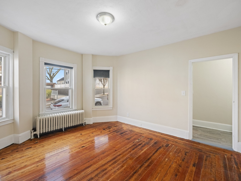 75 Bellingham Street Chelsea, MA 02150 - Photo 7 of 42 an empty room with wooden floor and windows