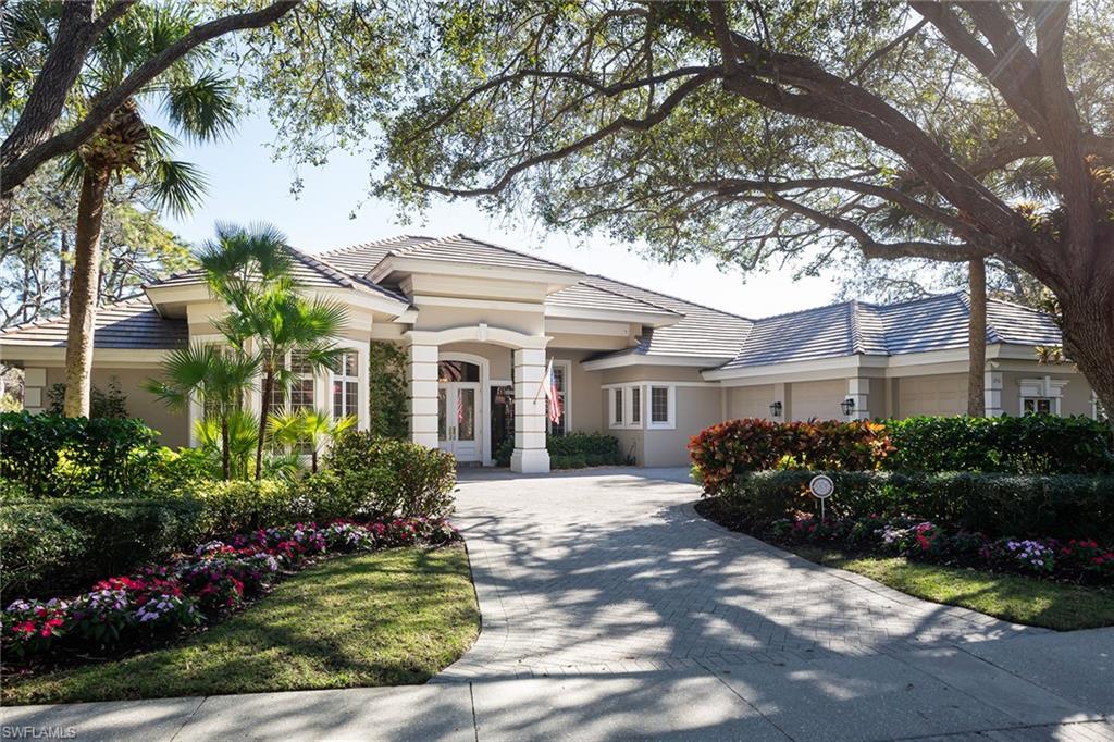 896 Barcarmil Way Naples, FL 34110 - Photo 1 of 45 a front view of a house with a garden