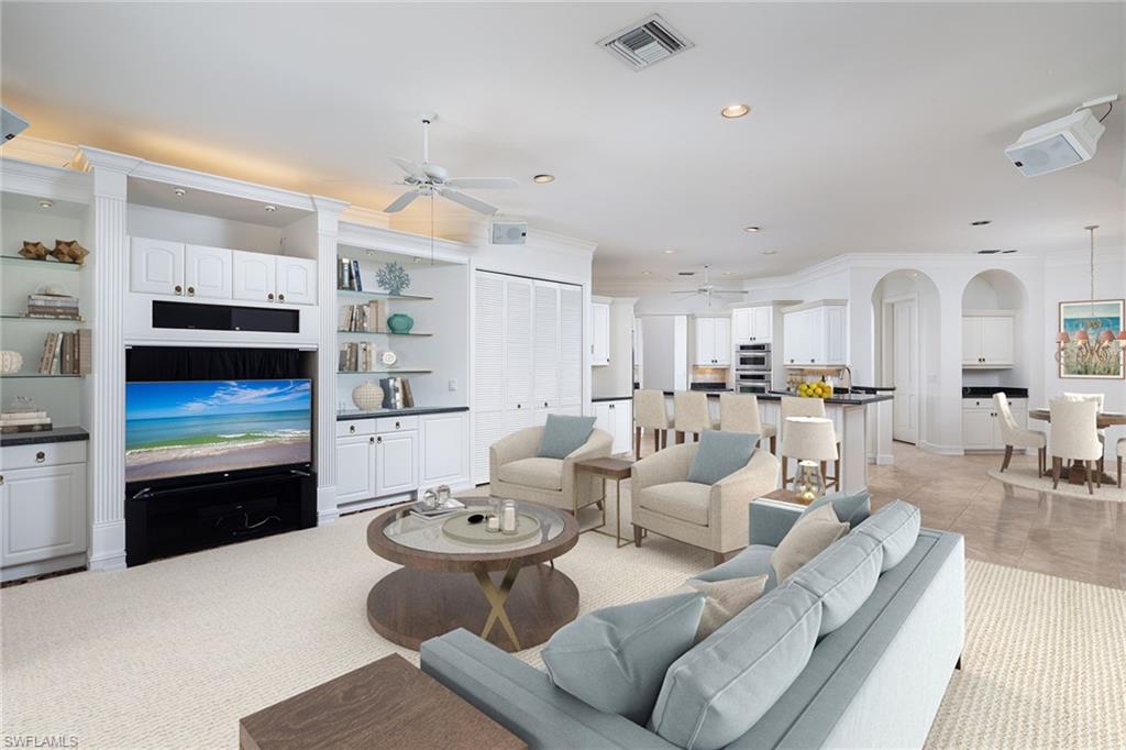 896 Barcarmil Way Naples, FL 34110 - Photo 12 of 45 a living room with furniture and kitchen view