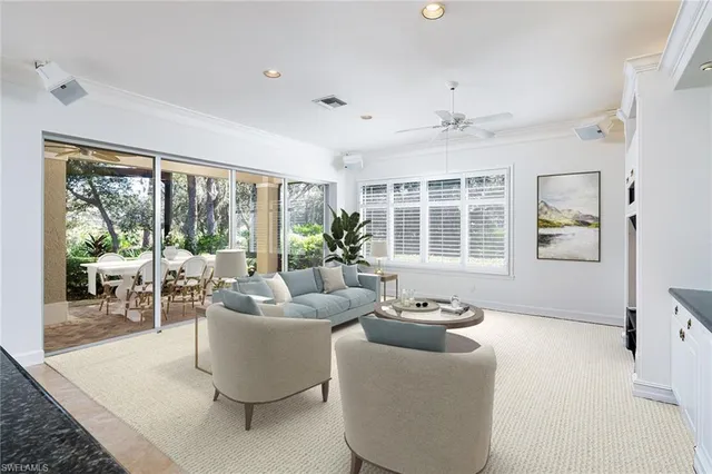 a living room with furniture and large windows