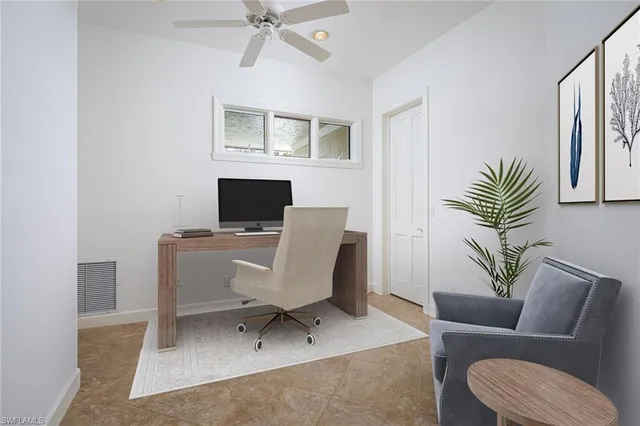 a work room with furniture and a window