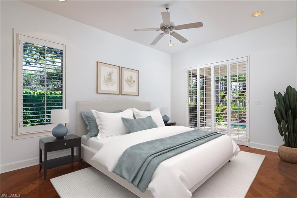 896 Barcarmil Way Naples, FL 34110 - Photo 22 of 45 a bedroom with a large bed and a window