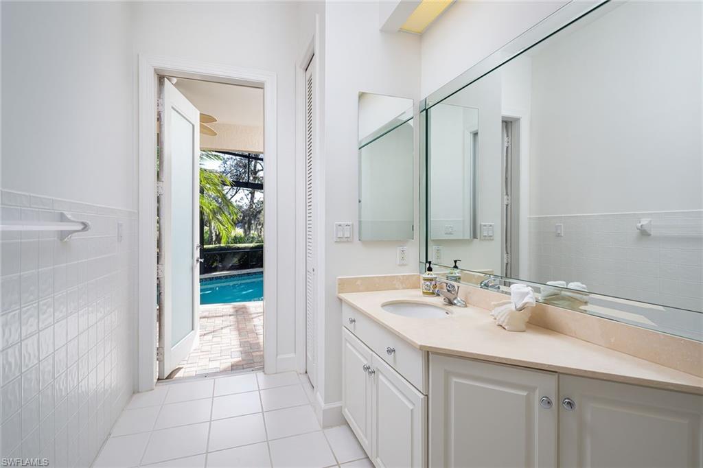 896 Barcarmil Way Naples, FL 34110 - Photo 23 of 45 a bathroom with a sink and a mirror