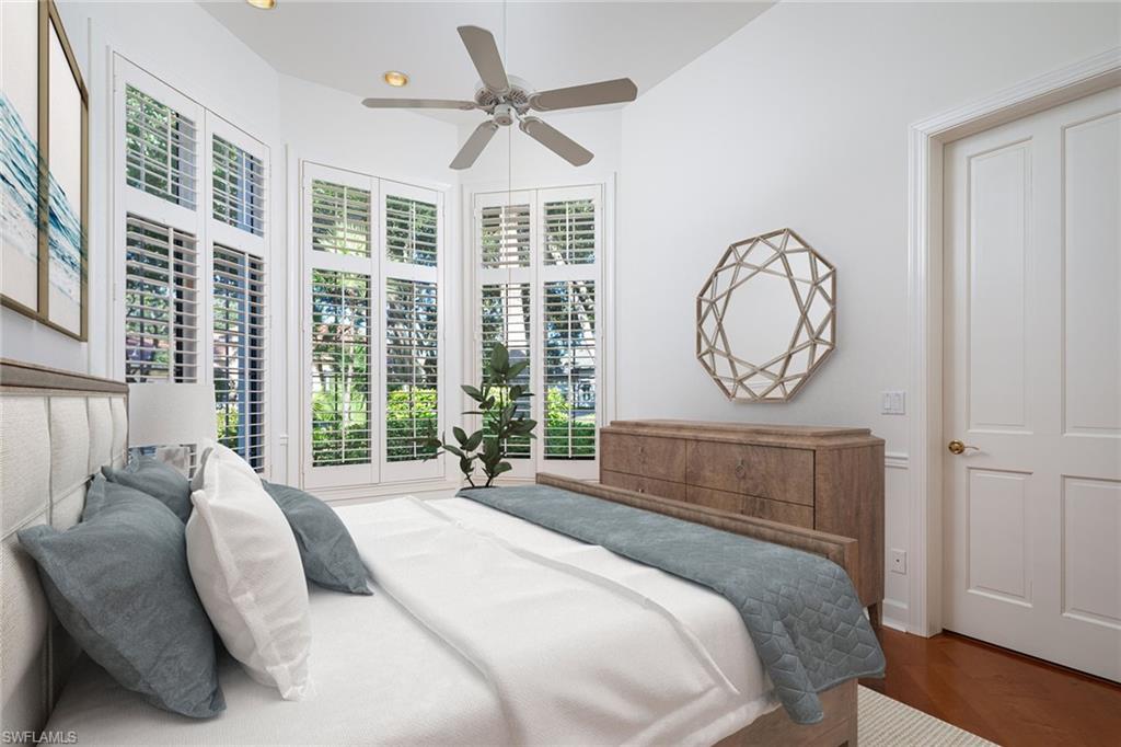 896 Barcarmil Way Naples, FL 34110 - Photo 25 of 45 a bedroom with a large bed and a large window
