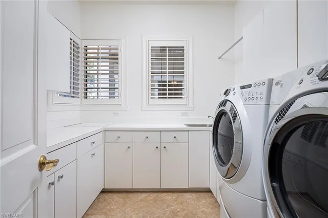 a utility room with multiple dryer and washer