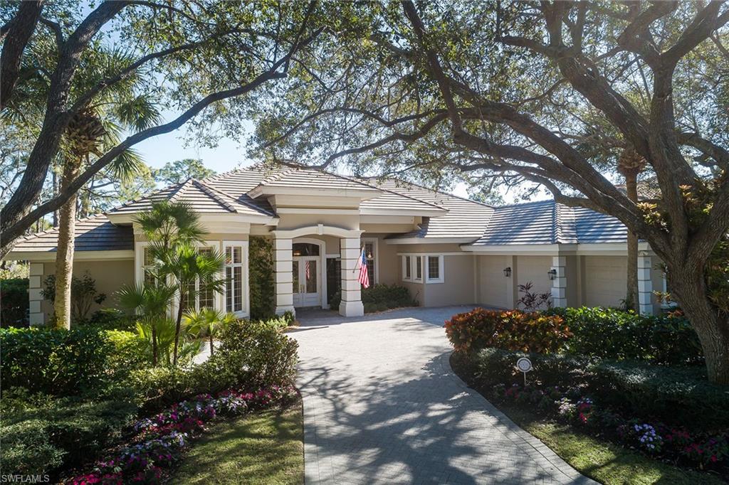 896 Barcarmil Way Naples, FL 34110 - Photo 29 of 45 a front view of a house with a garden