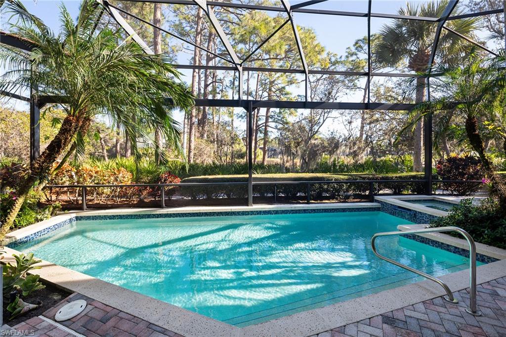 896 Barcarmil Way Naples, FL 34110 - Photo 3 of 45 a view of swimming pool with lawn chairs and plants