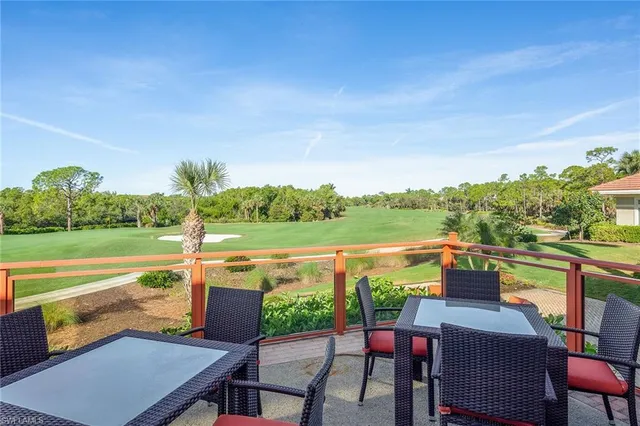 a view of swimming pool with outdoor seating and lake