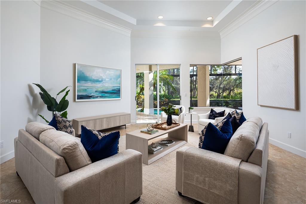 896 Barcarmil Way Naples, FL 34110 - Photo 7 of 45 a living room with furniture and a large window