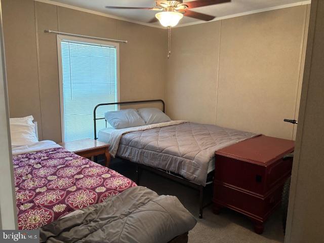31706 Janice Road Lewes, DE 19958 - Photo 11 of 20 a bedroom with a bed and a chandelier