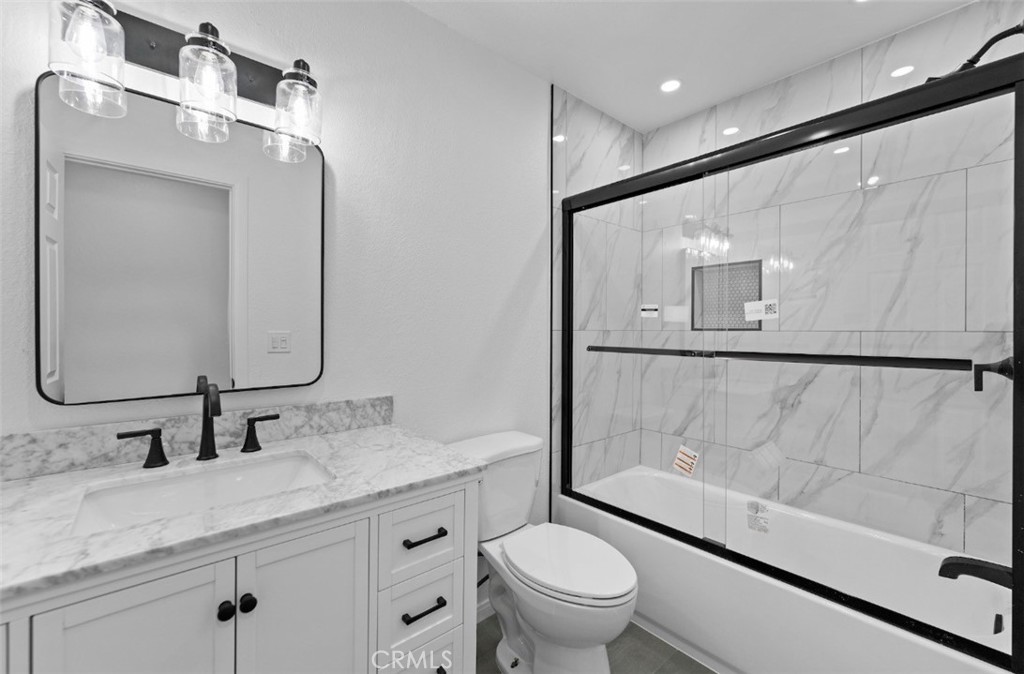15352 Linden Street Hesperia, CA 92345 - Photo 16 of 39 a bathroom with a granite countertop sink mirror vanity and toilet