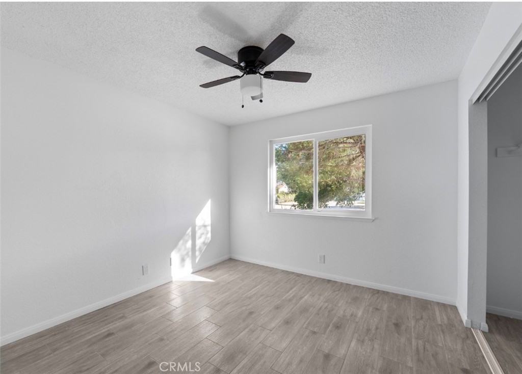 15352 Linden Street Hesperia, CA 92345 - Photo 20 of 39 an empty room with wooden floor and windows