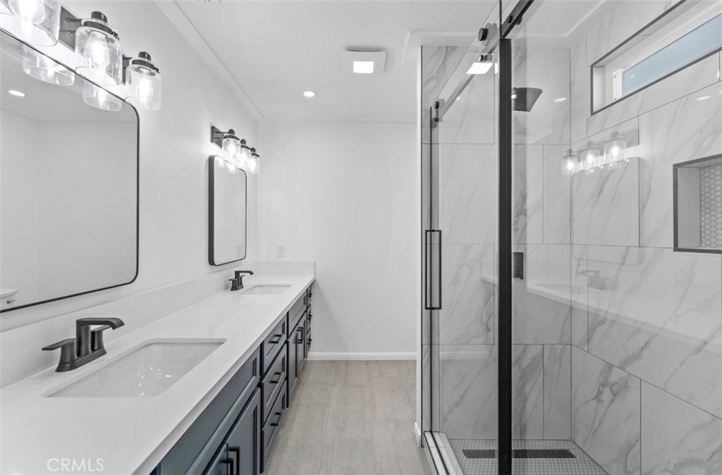 15352 Linden Street Hesperia, CA 92345 - Photo 24 of 39 a bathroom with a double vanity sink a mirror and shower