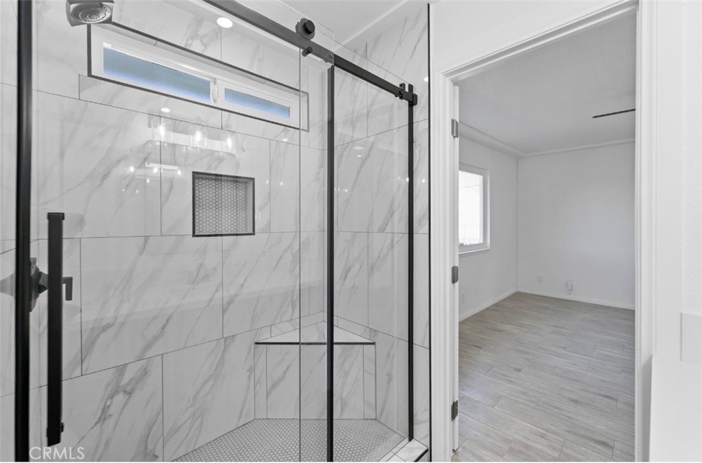 15352 Linden Street Hesperia, CA 92345 - Photo 27 of 39 a bathroom with a glass shower door and mirror