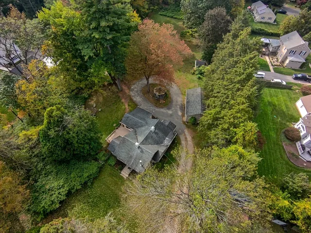 an aerial view of a house with a yard
