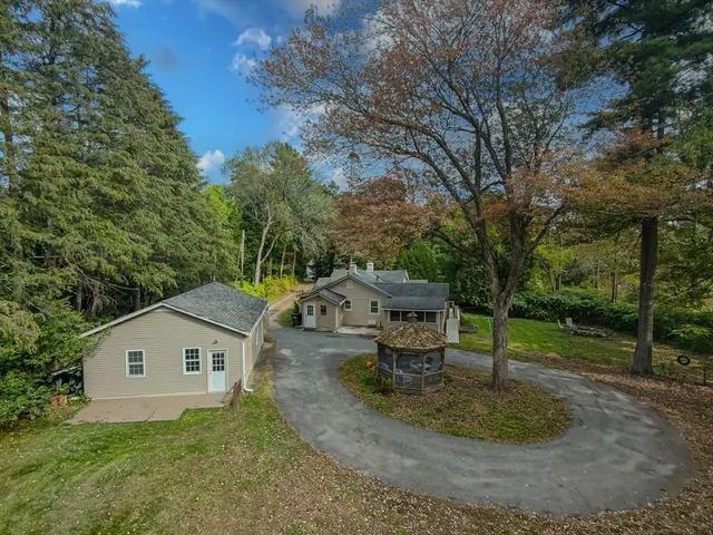 a backyard of a house with table and chairs