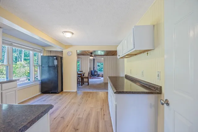 a kitchen with granite countertop a refrigerator and a sink
