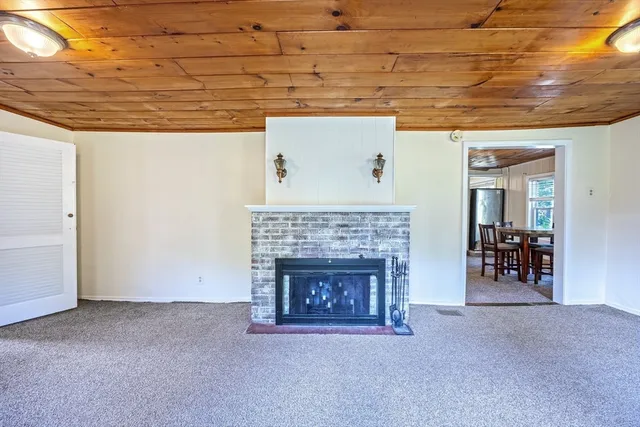 a view of a livingroom with an empty space and a fireplace