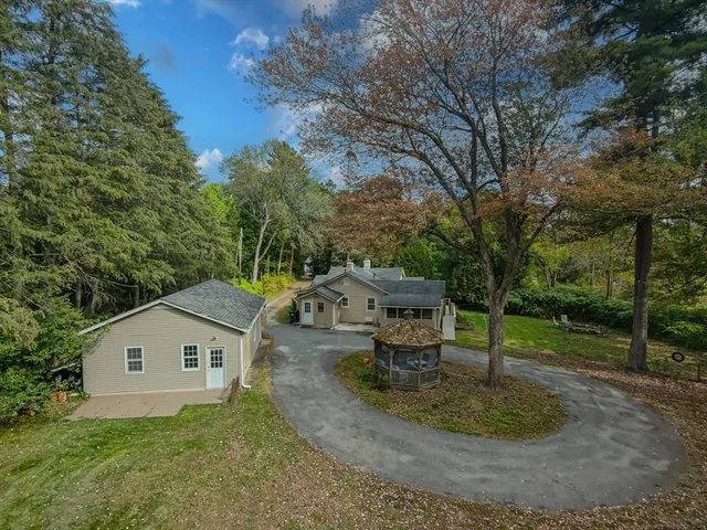 a backyard of a house with table and chairs