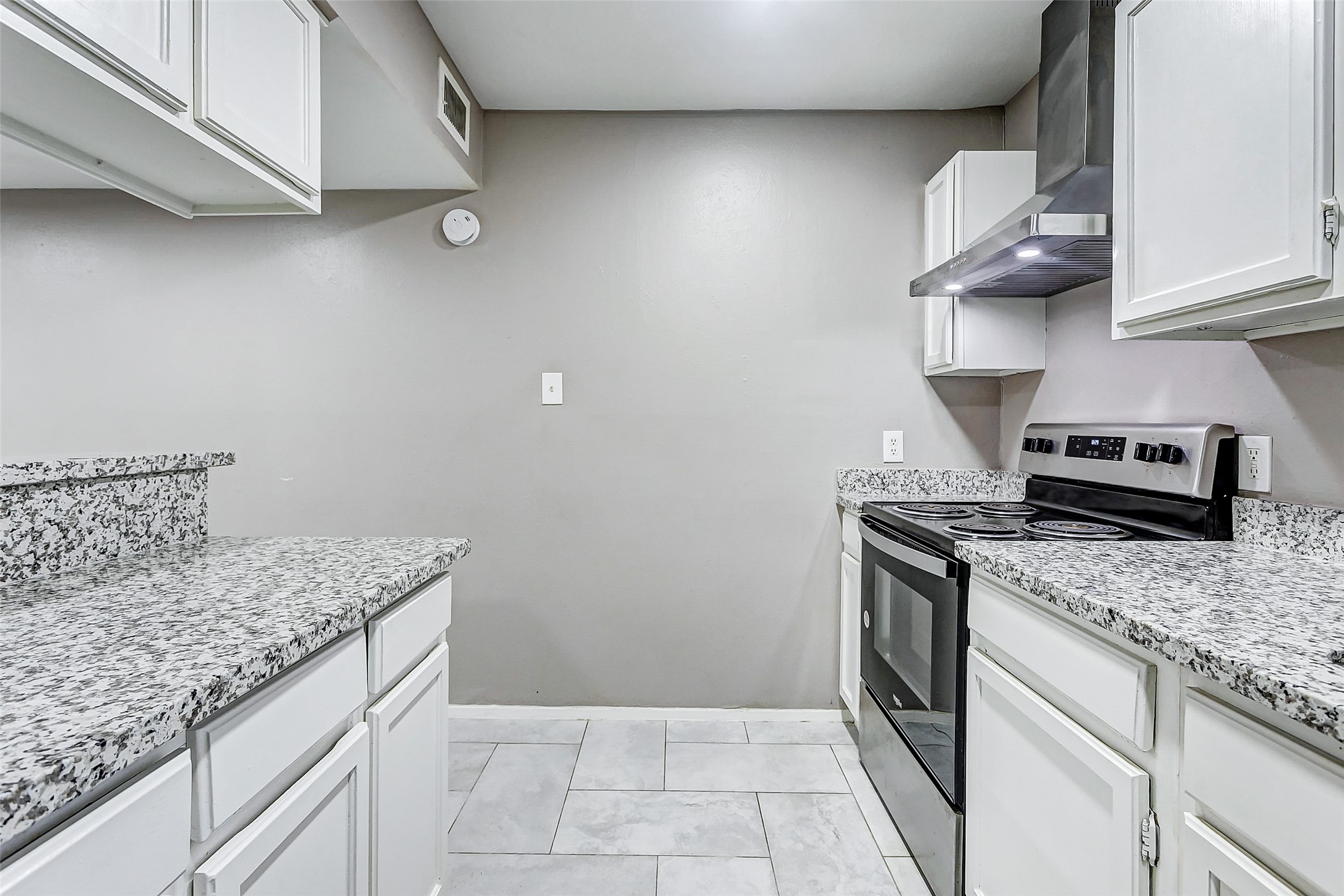 22910 Summer Green Lane Spring, TX 77373 - Photo 11 of 18 a kitchen with granite countertop a sink a stove and cabinets