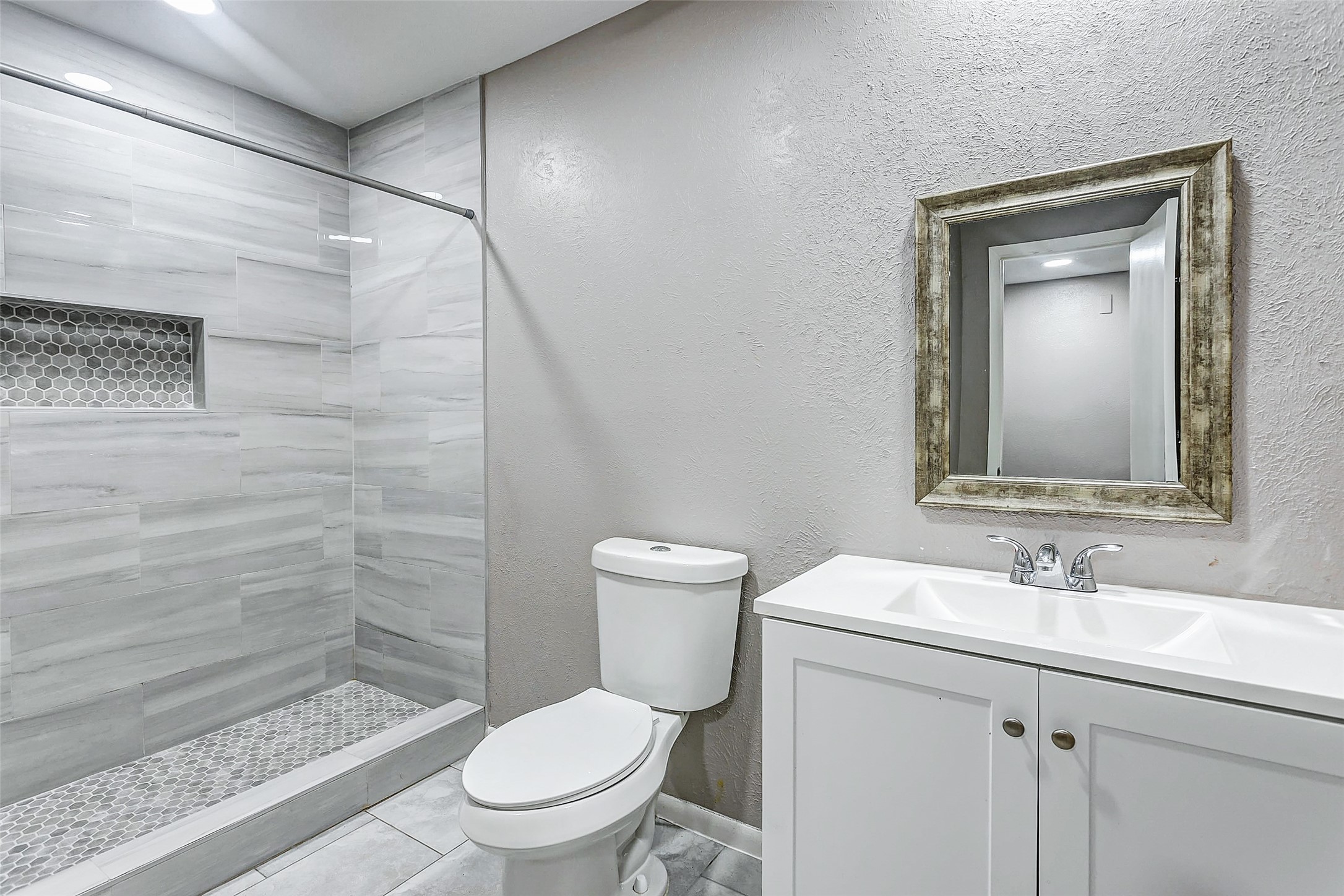 22910 Summer Green Lane Spring, TX 77373 - Photo 13 of 18 a bathroom with a sink a toilet and shower