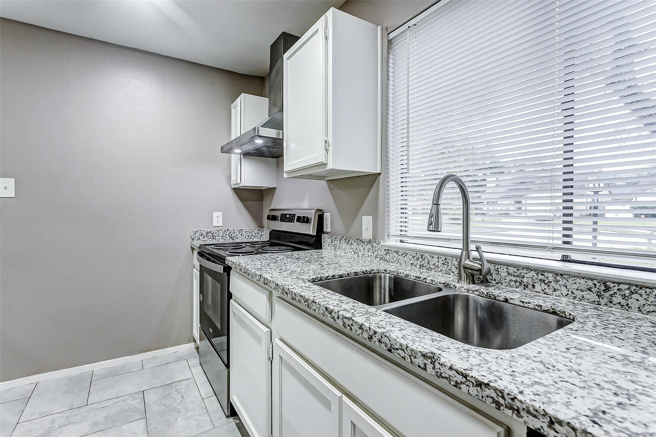 22910 Summer Green Lane Spring, TX 77373 - Photo 10 of 18 a kitchen with stainless steel appliances granite countertop a sink and a white wooden cabinets
