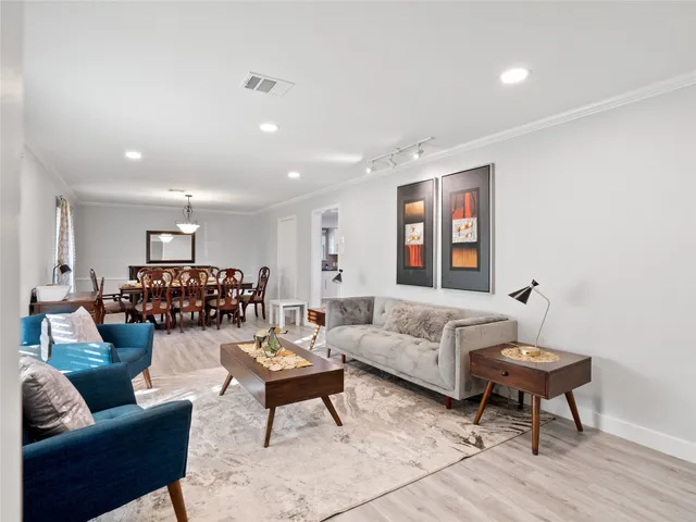 a living room with furniture and wooden floor