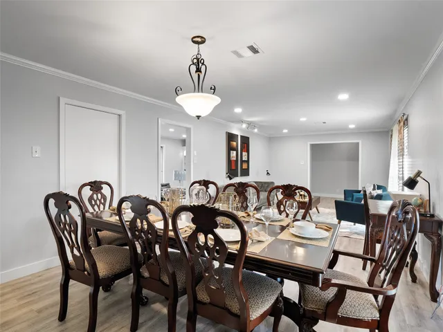 a view of a a dining room with furniture window and wooden floor