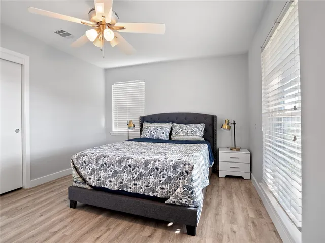 a bedroom with a bed and a window