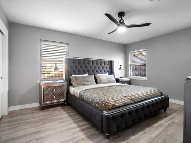 a bedroom with a bed and a ceiling fan