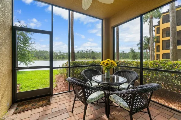 a dining room with furniture and a floor to ceiling window