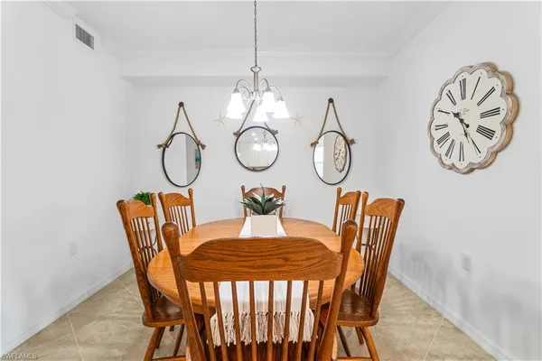 a view of a dining room with furniture and chandelier