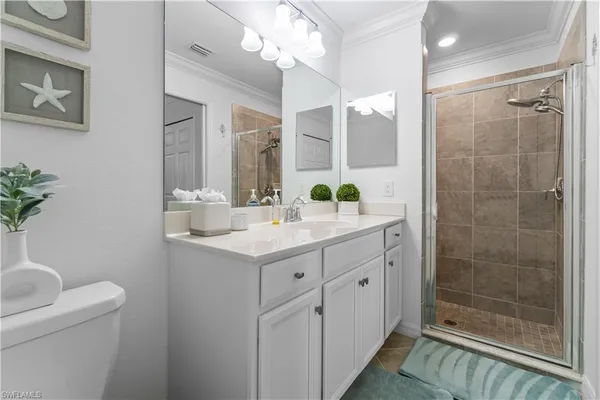 a bathroom with a shower sink and mirror