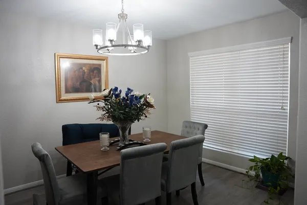 a dining room with furniture and chandelier