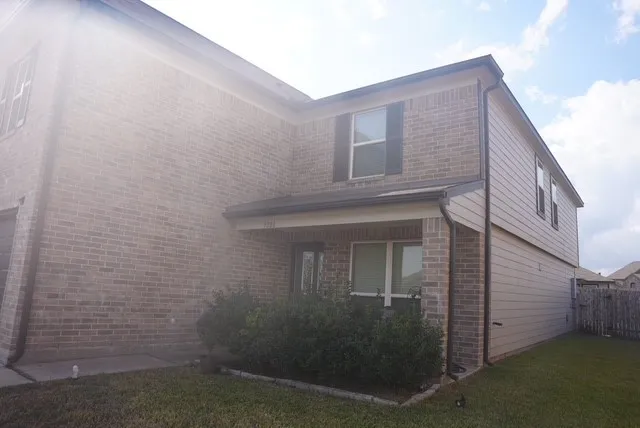 a view of a brick house with many windows