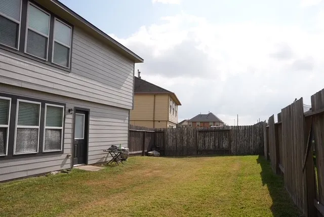 a view of a house with wooden fence