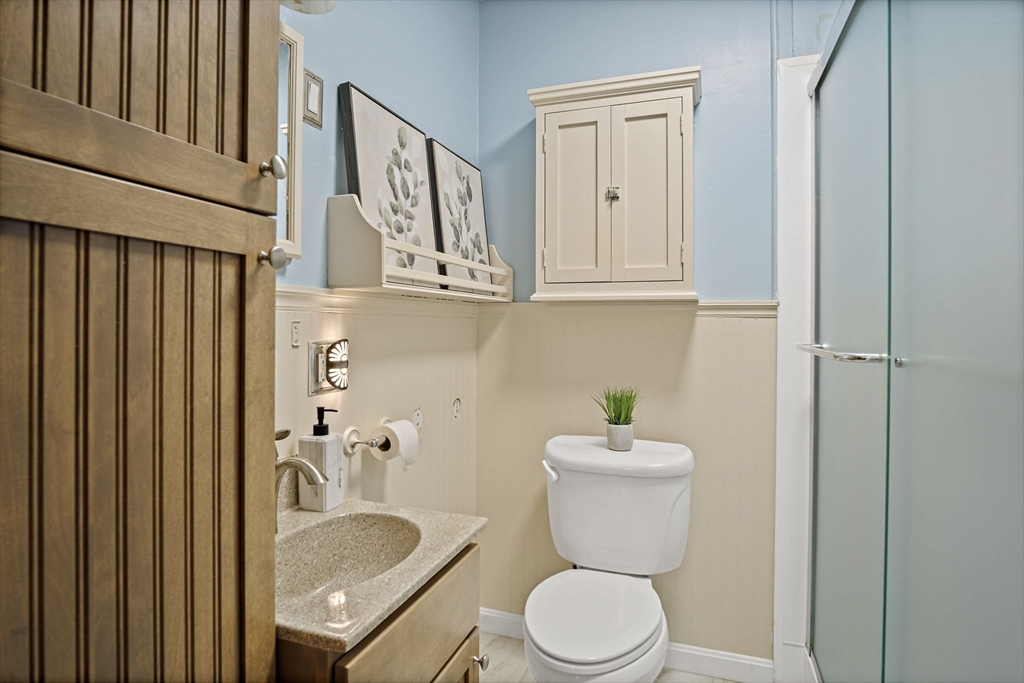 56 Summer Street Saugus, MA 01906 - Photo 16 of 29 a bathroom with a granite countertop toilet sink and mirror